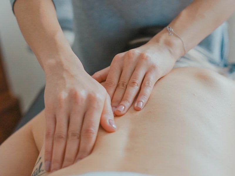 Close-up of hands applying measured pressure during a relaxing session